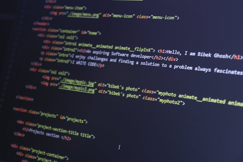 A detailed digital photograph of code displayed on a computer screen, showing colorful HTML and CSS syntax. The code includes tags such as <h1>, <div>, and <img>, with class attributes like 'real colo